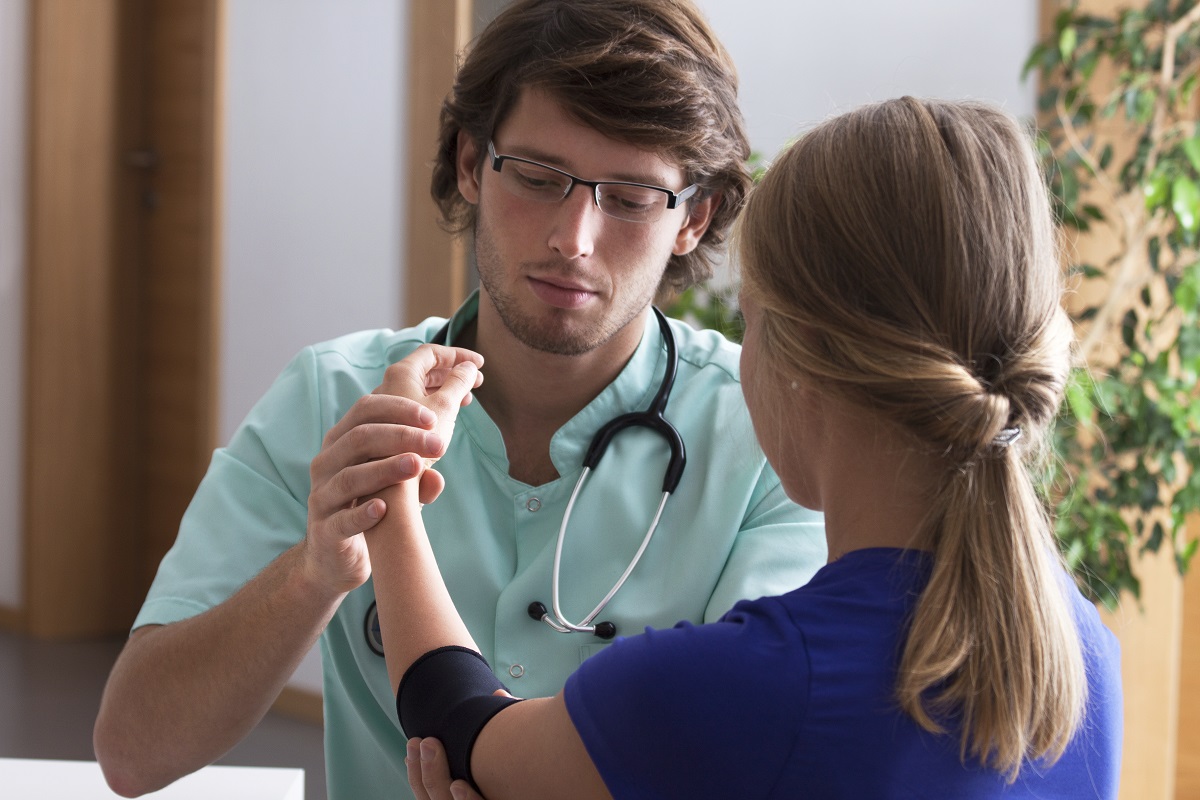 Orthopedist examining elbow