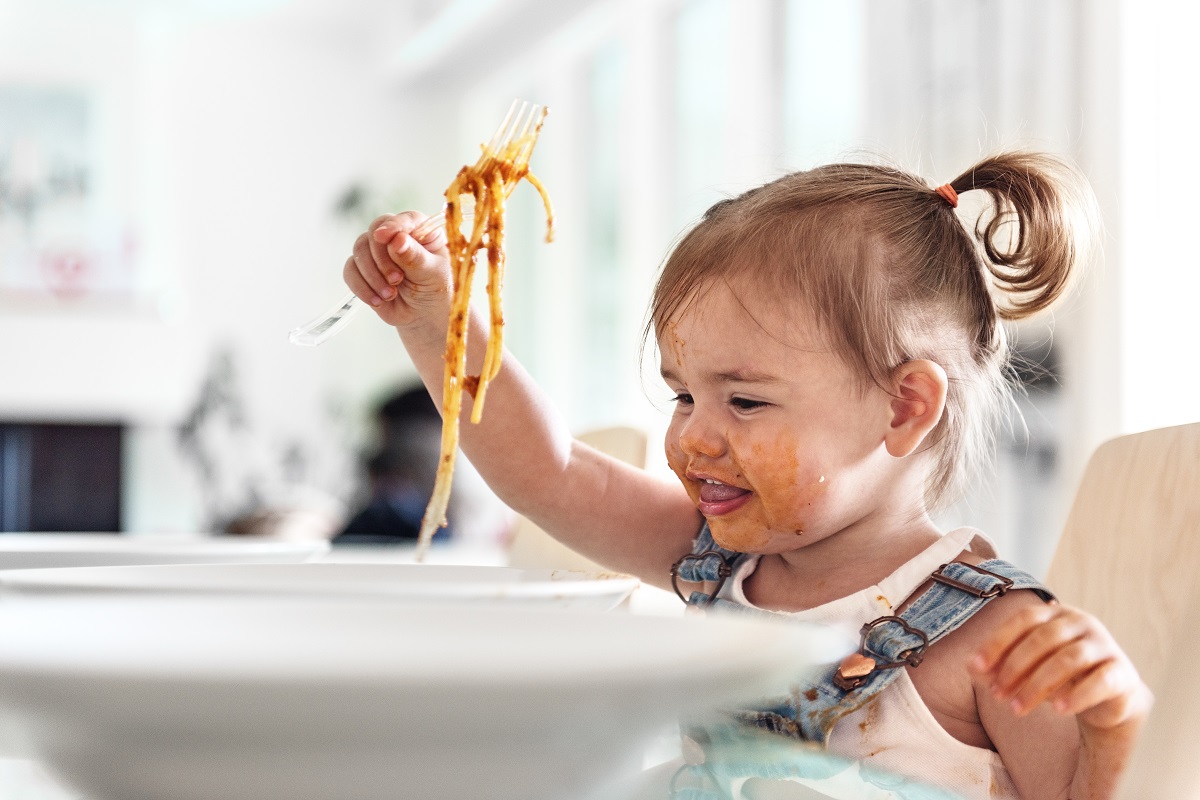 Little girl 2 years old girl eating noodles