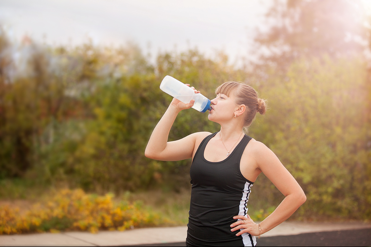 Woman drinking water during sports