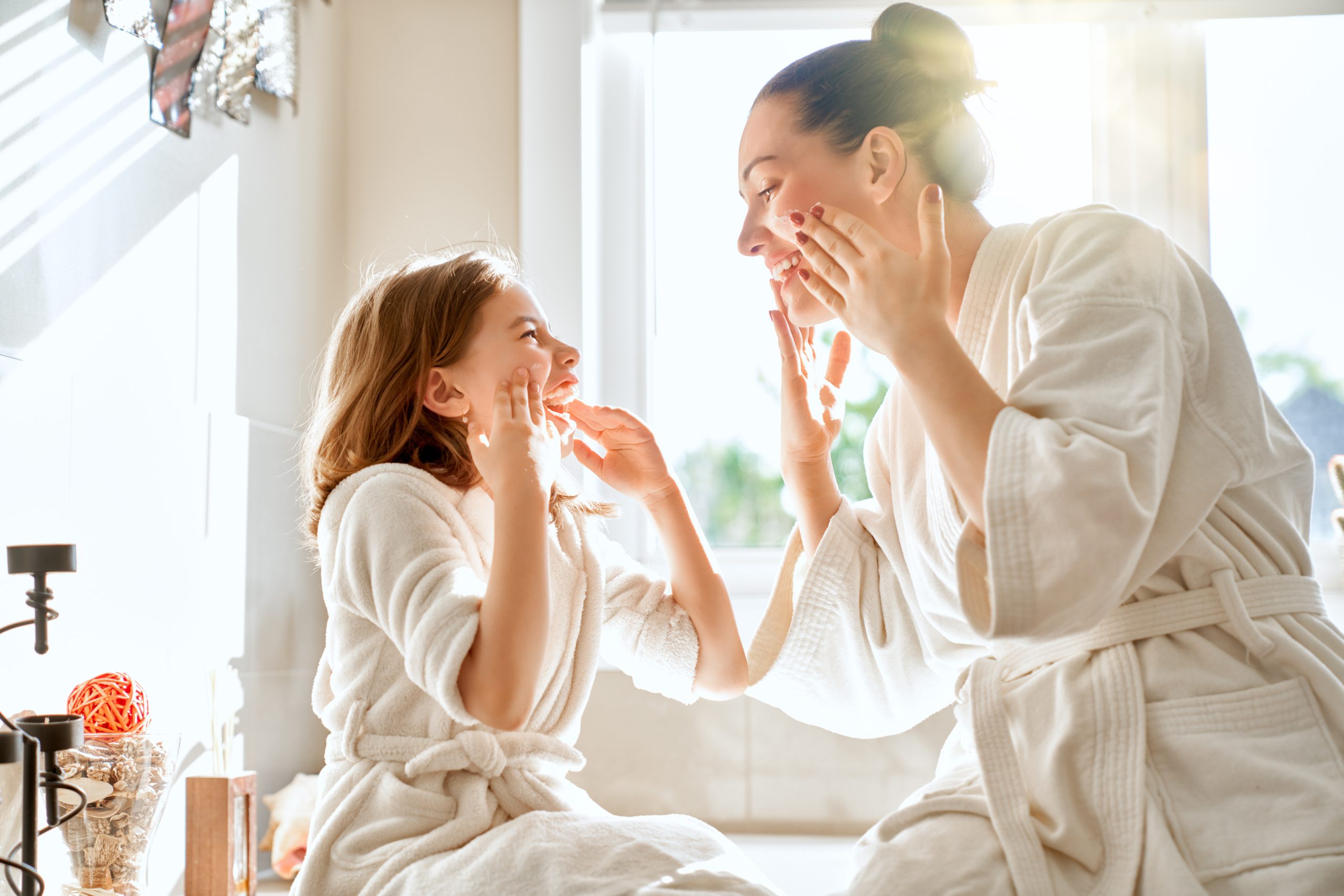 Mother and daughter caring for skin